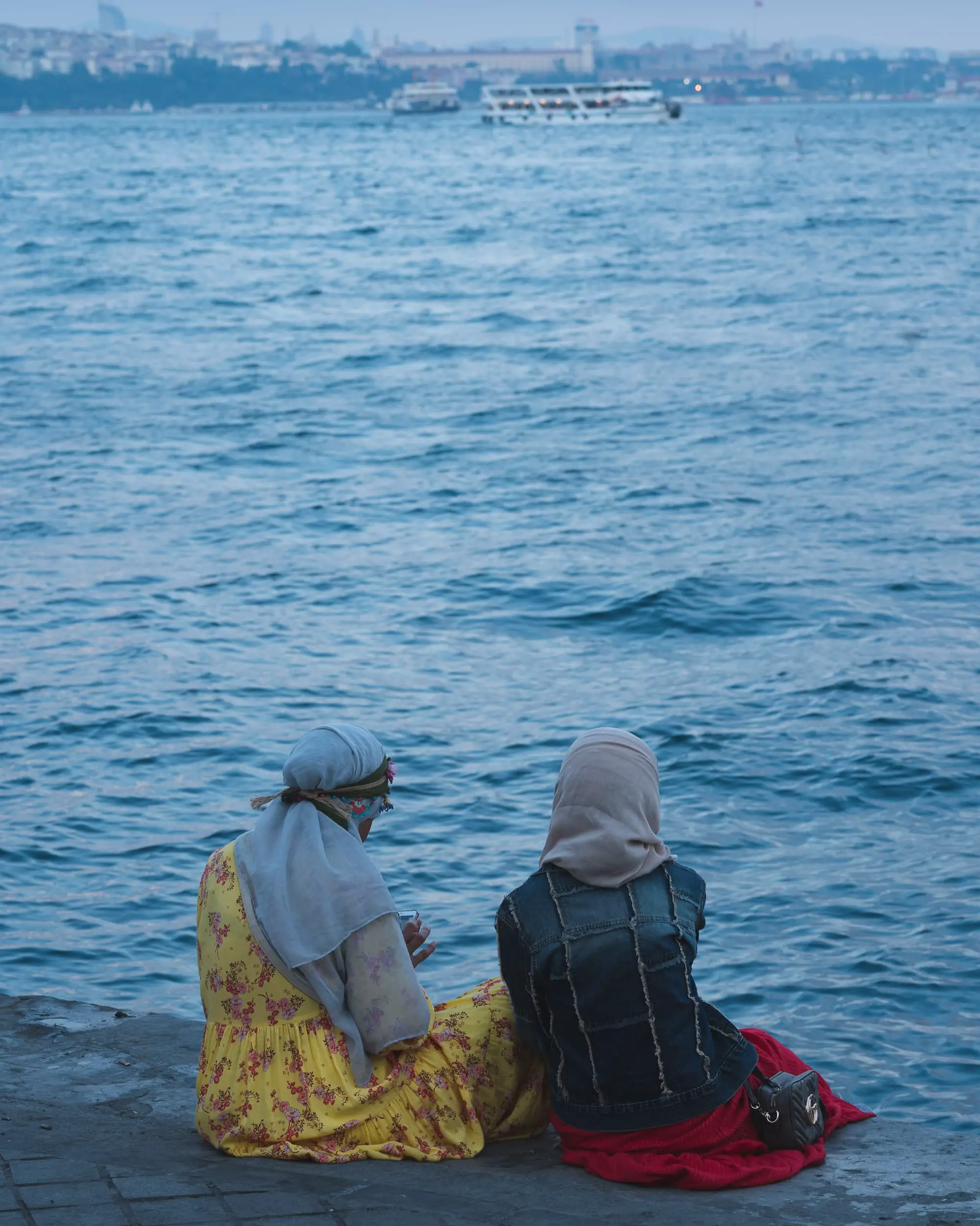 turkish women sitting at bosphorus