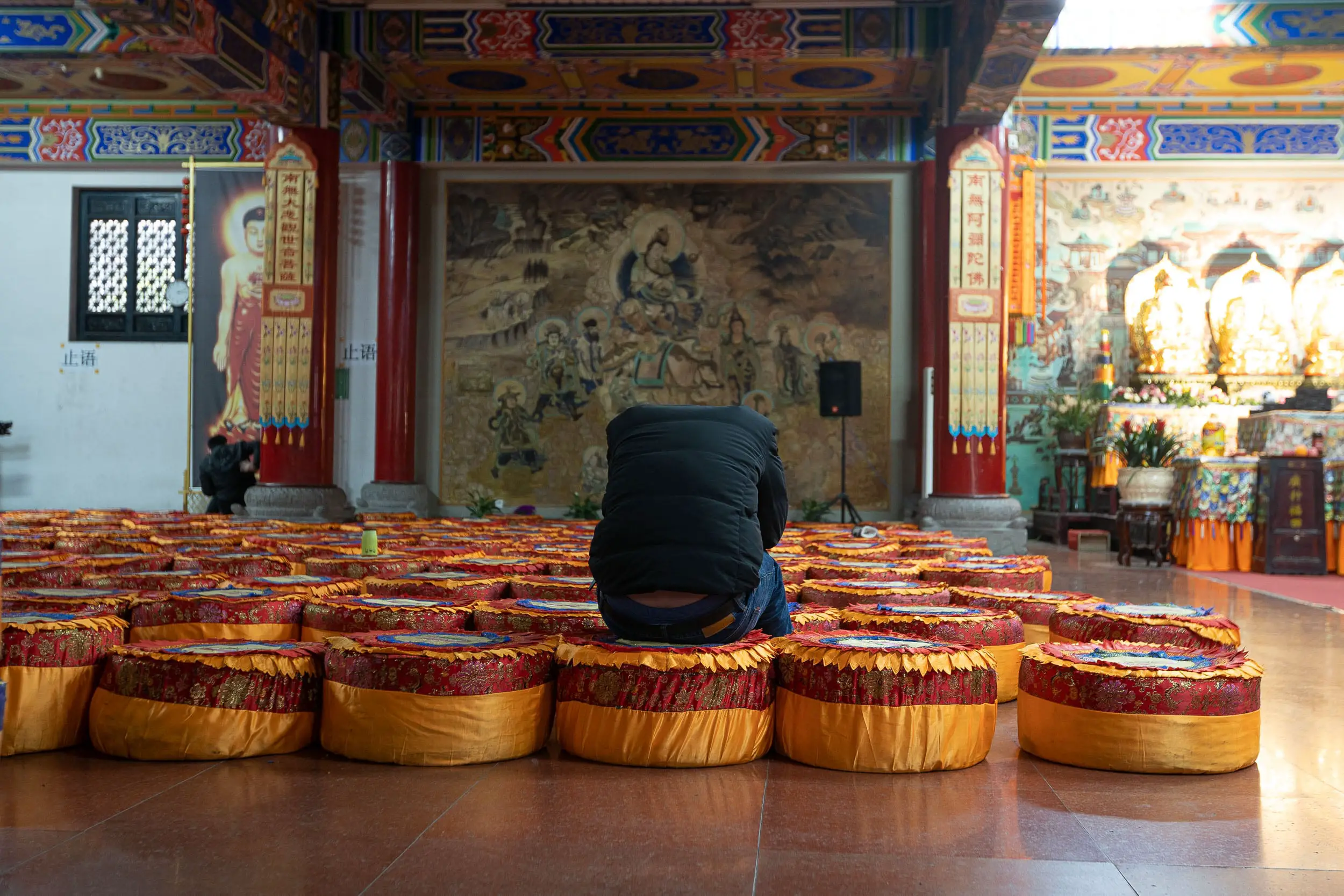 man praying at temple chengdu